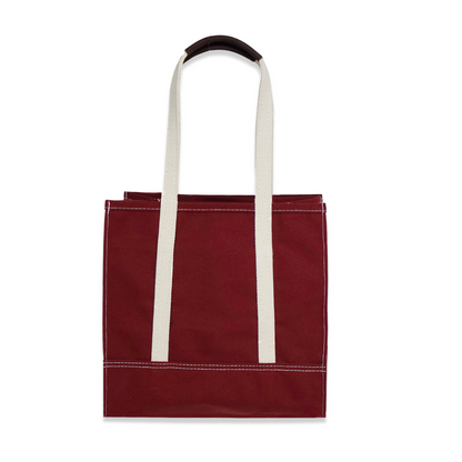 Red tote bag with white handles on a white background