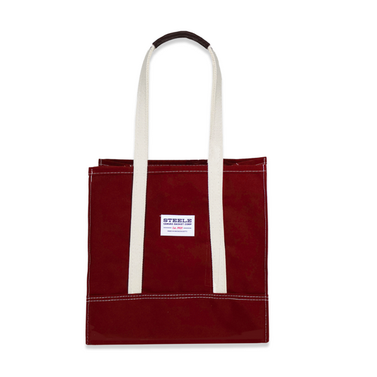 Red tote bag with white handles on a white background