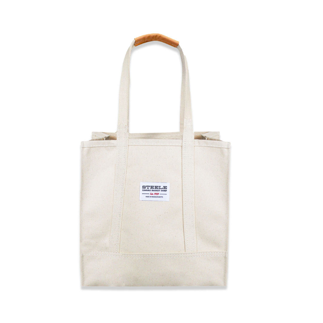 Beige tote bag with a small label on a white background