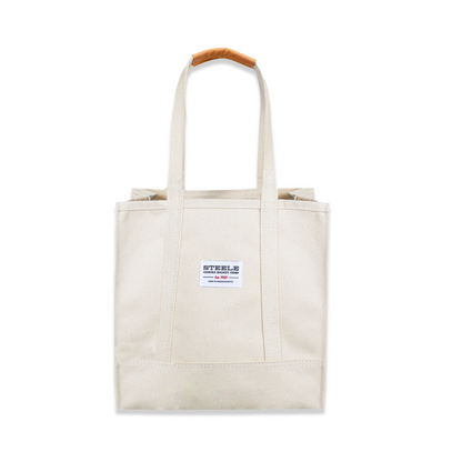 Beige tote bag with a small label on a white background