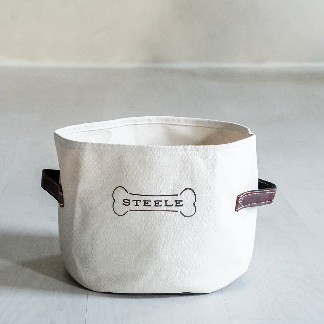 White storage bin made for dogs with 'STEELE' branding on a light gray background