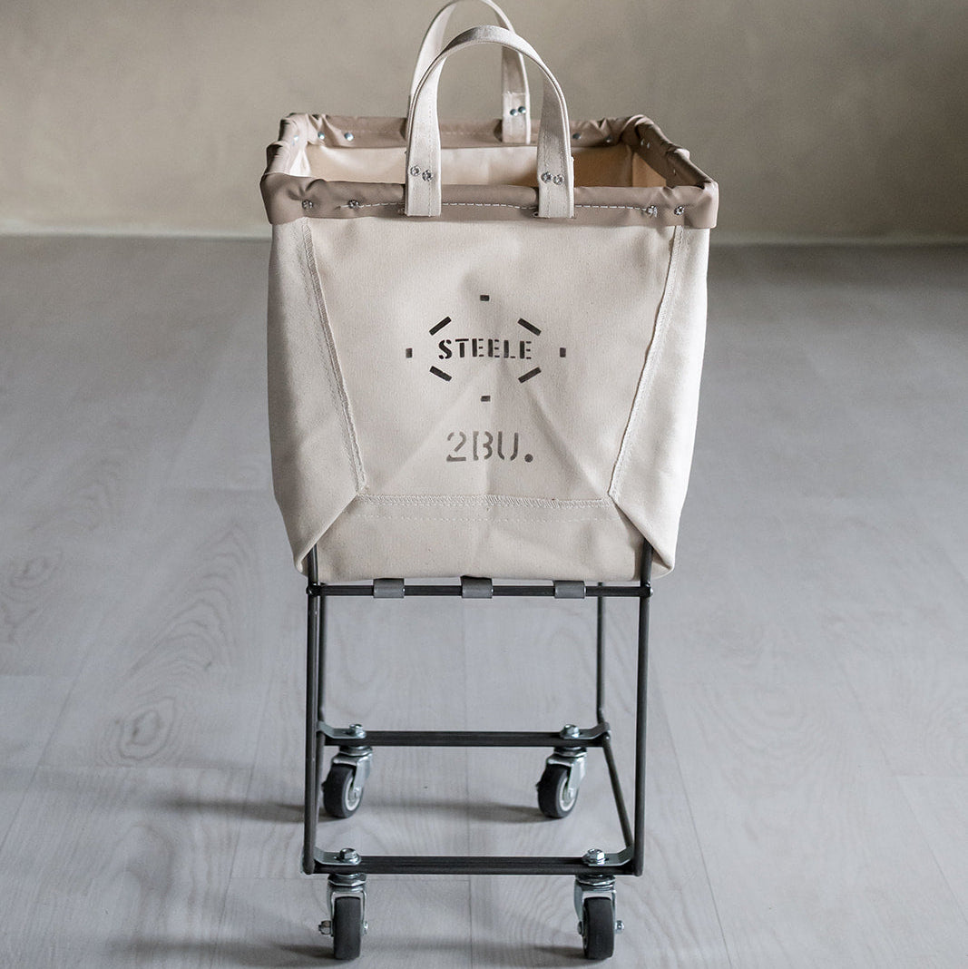 Beige laundry truck with 'Steele' branding on a gray floor.