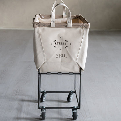 Beige laundry truck with 'Steele' branding on a gray floor.