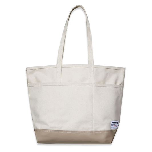 Beige tote bag with a visible brand label on a white background