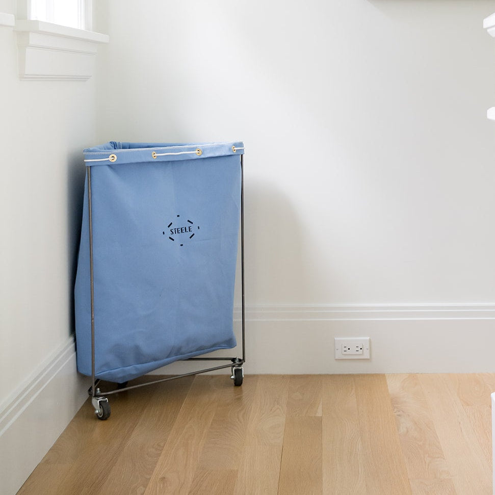 corner laundry basket in a sky blue color