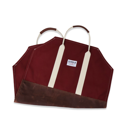 Red log carrier with brown accents and white straps on a white background