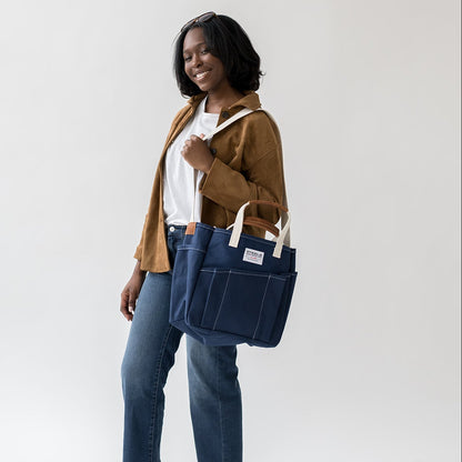 woman posing with navy blue utility tote bag