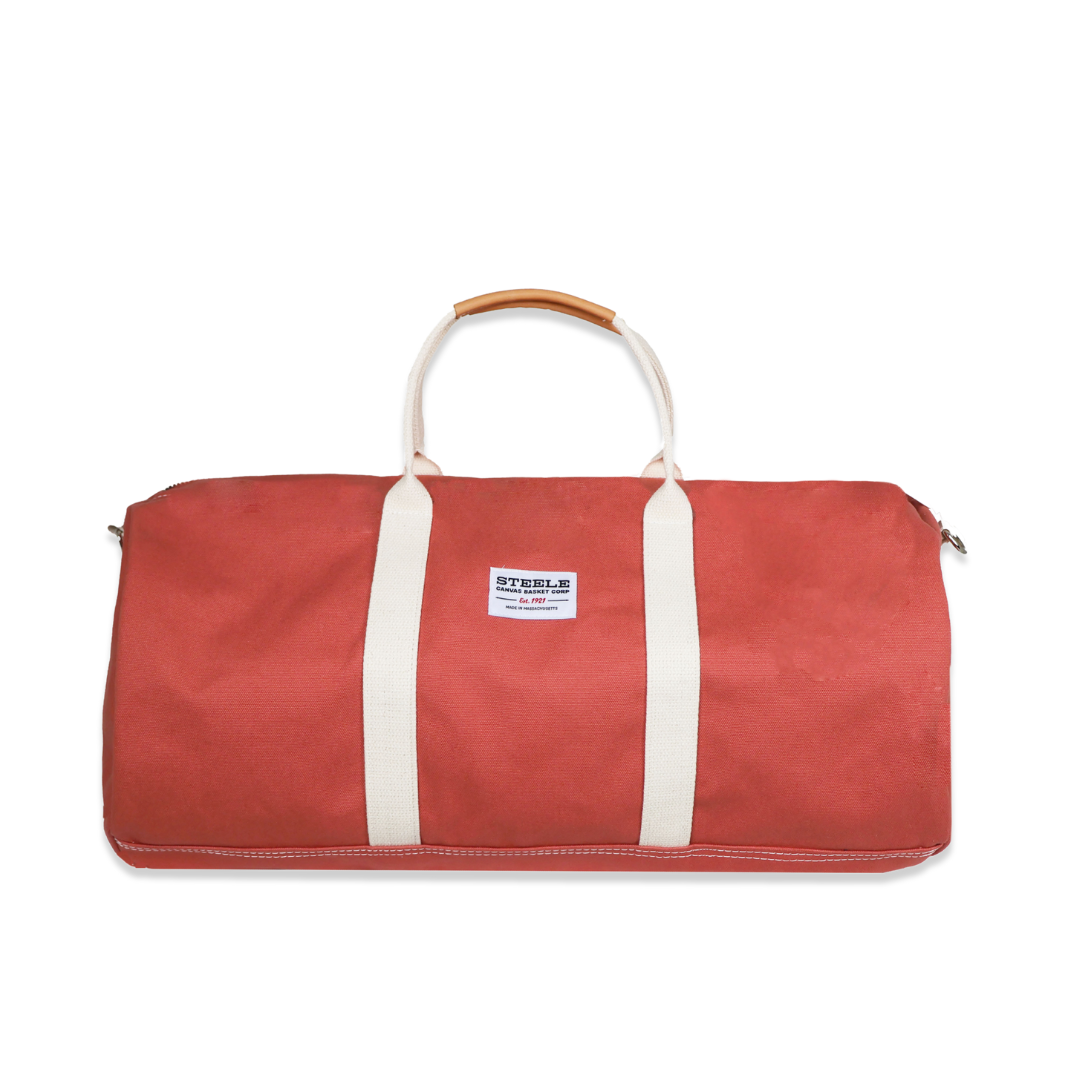 Red duffel bag with white straps on a white background