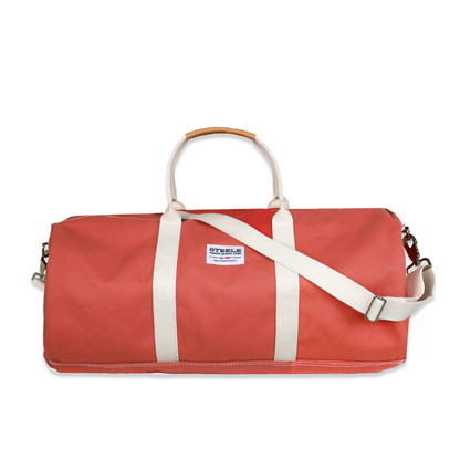 Red duffel bag with white straps on a white background