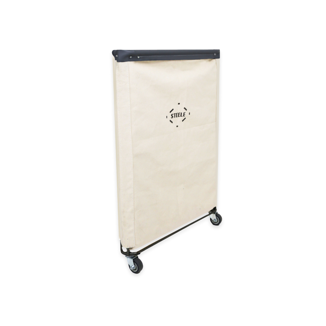 side angle of a natural canvas laundry hamper with a black leather rim