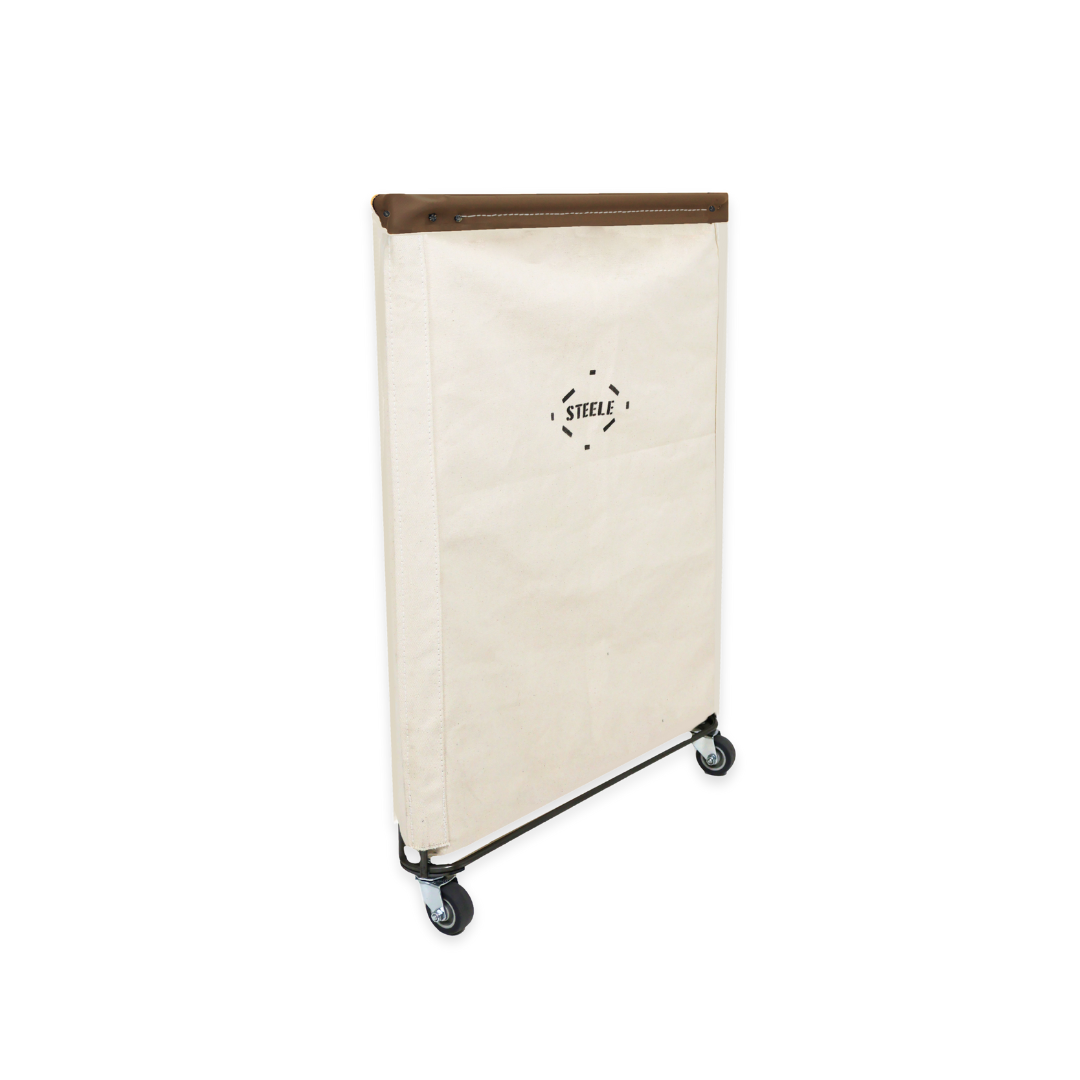side angle of a natural canvas laundry hamper with a brown leather rim