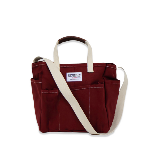 Red tote bag with a white strap on a white background