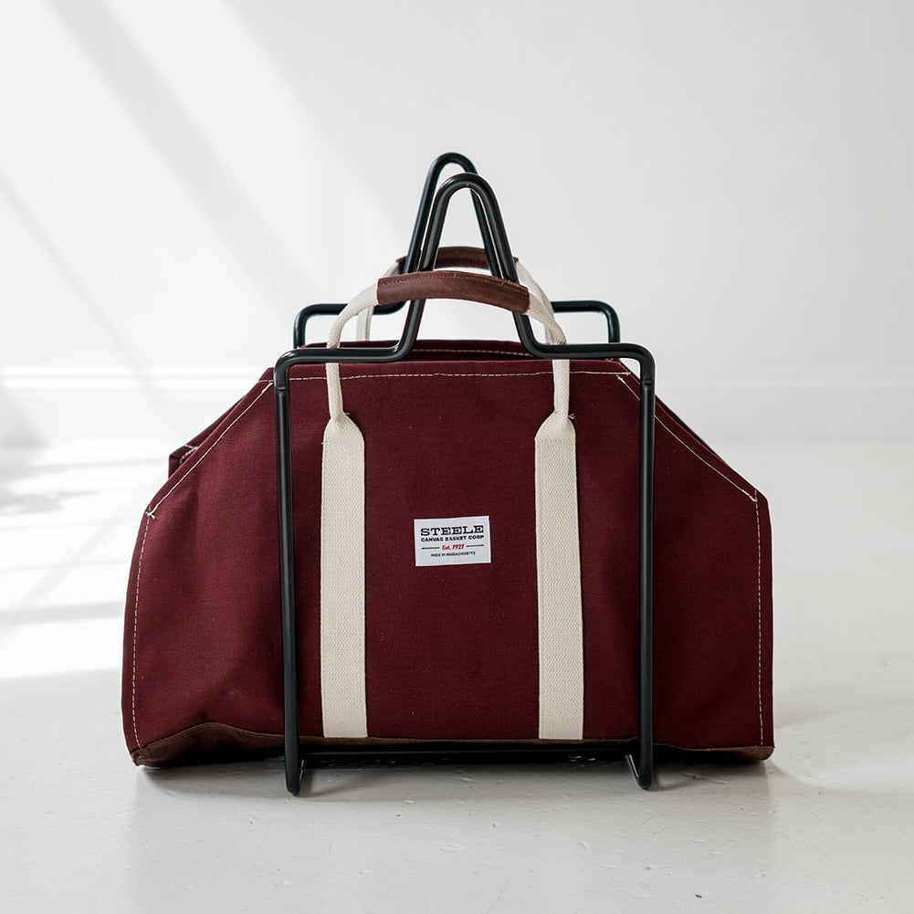 Maroon log carrier with white stripes and a visible brand label on a white background