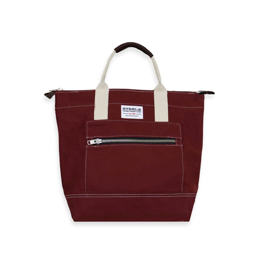 Maroon tote bag with white handles on a white background