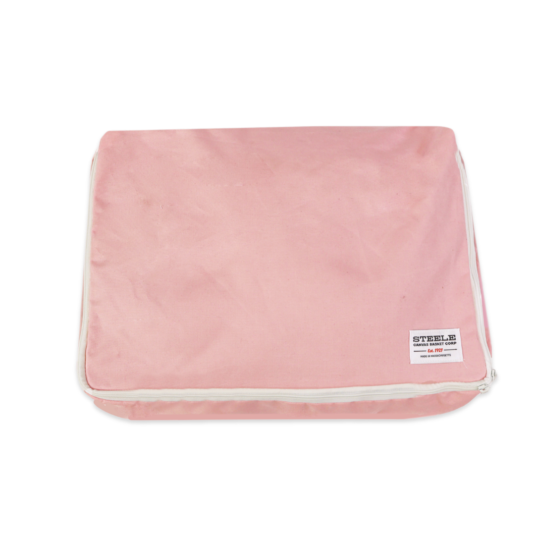 A pink rectangular canvas pouch with white piping and a small white brand label reading STEELE on a plain white background.